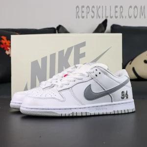 Nike Supreme x Dunk Low SB “White Metallic Silver” pair display with Nike box in the background, emphasizing premium presentation.