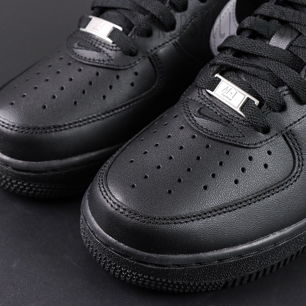 Close-up of Supreme x Nike Air Force 1 Low SP ‘Box Logo - Black White’ toe area showing perforated leather and metal lace tag