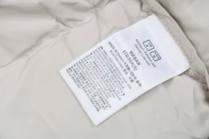 The North Face x KAWS 1996 Retro Nuptse Down Jacket Grey Wash label
