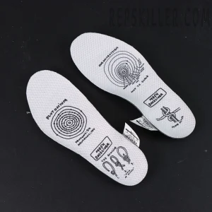 Pair of printed white insoles with Tom Sachs signature-style graphics.