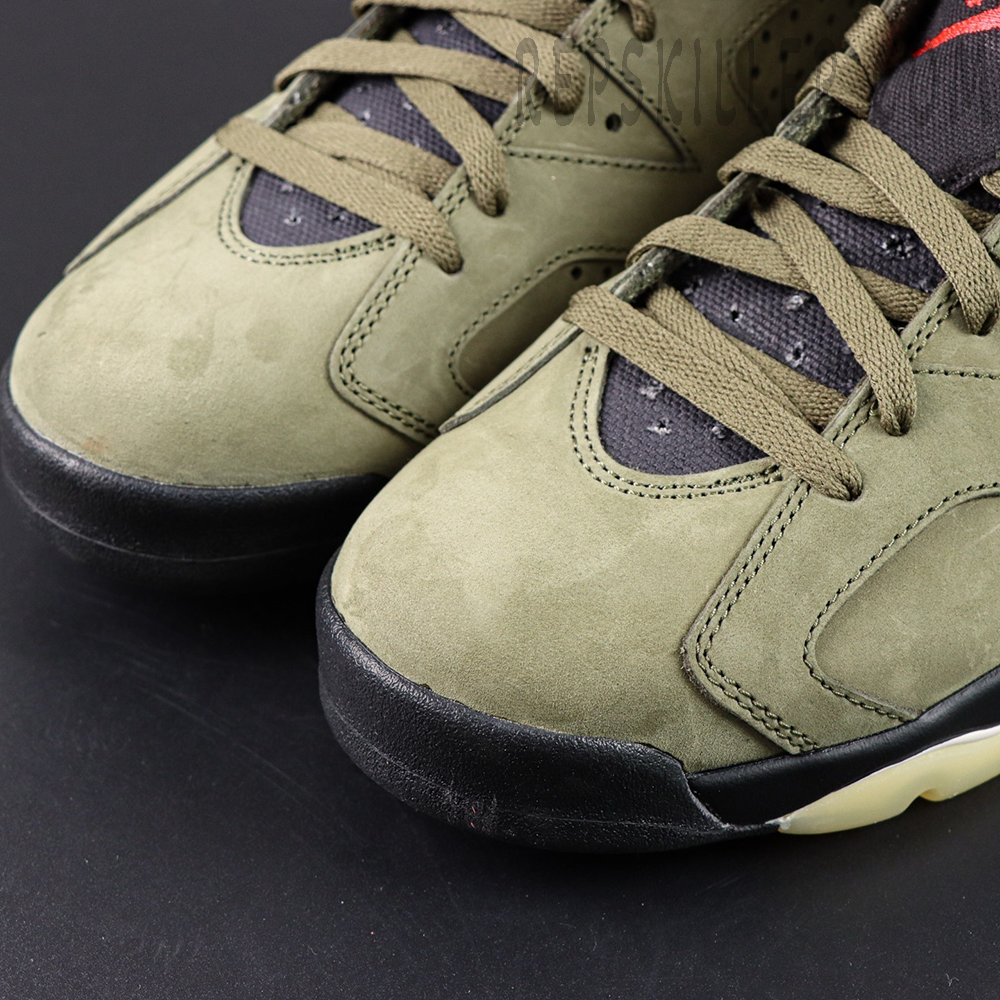 Close-up of Travis Scott x Air Jordan 6 “Olive” toe box showing suede texture and stitching details.