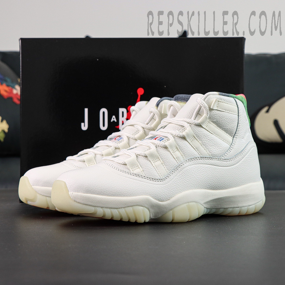 Jordan 11 Retro ‘285’ white leather sneakers with multicolor collar displayed in front of the black Jordan box.