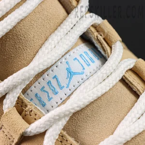 Close-up of the tongue label with light blue Jumpman branding and white laces on the Jordan 11 Retro ‘H-Town’.