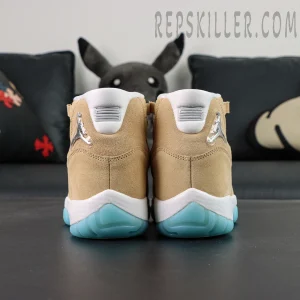 Straight rear view of the Jordan 11 Retro ‘H-Town’ showing the tan suede heel, white tabs and icy blue heel outsole.