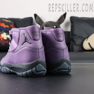 Rear view of the Jordan 11 Retro ‘Mojave’ with black heel branding and purple suede construction.