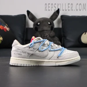Lateral side profile of Off-White x Nike Dunk Low Lot 38 of 50 with grey suede and blue overlace