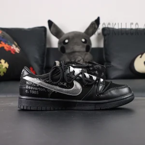 Side profile of Off-White x Nike Dunk Low Lot 50 of 50 with metallic Swoosh and Off-White text print.