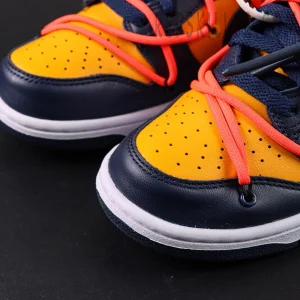 Close-up of toe box on Off-White x Nike Dunk Low University Gold showing perforations and orange lace overlay