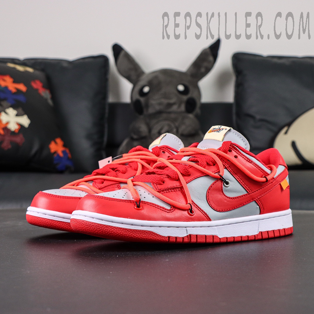 Off-White x Nike Dunk Low “University Red” shown in a front three-quarter angle, featuring red leather overlays, grey panels, and signature orange secondary lacing.