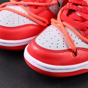 Heel-side angle of the Off-White x Dunk Low “University Red” focusing on the orange tab, exposed stitching, and sculpted midsole.