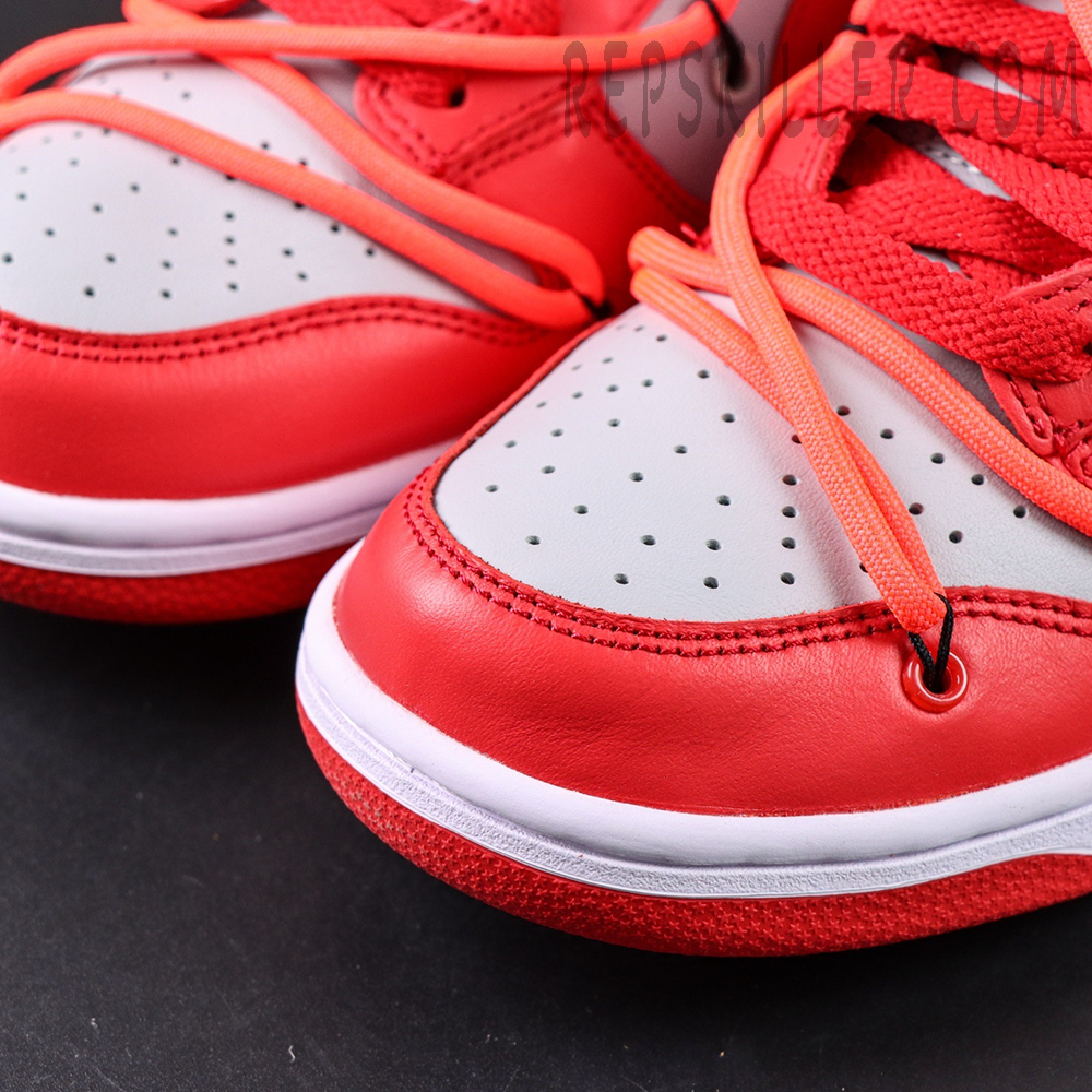 Heel-side angle of the Off-White x Dunk Low “University Red” focusing on the orange tab, exposed stitching, and sculpted midsole.