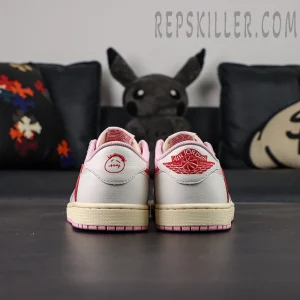 Rear view of the Travis Scott x Air Jordan 1 Low OG “Tropical Pink” showing the red Air Jordan Wings logo and Cactus Jack smiley embroidery on the heels.