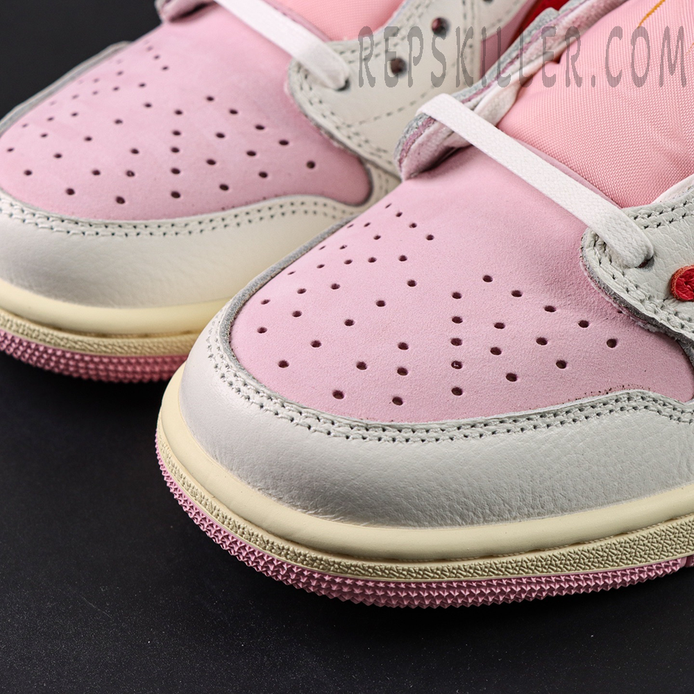 Close-up of the toe box on the Travis Scott x Air Jordan 1 Low OG “Tropical Pink,” showing pink nubuck and perforation details.