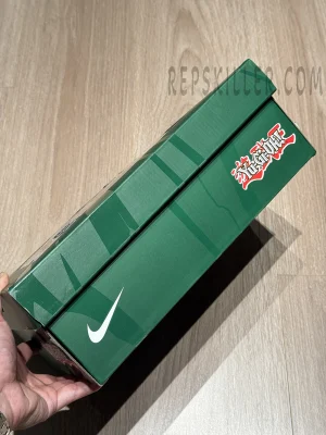 Green special-edition shoe box of the Yu-Gi-Oh! x Nike Air Max Muscle 95 QS featuring Nike logo and YU-GI-OH! graphics.