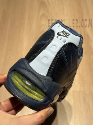 Close-up rear detail showing Nike Air branding and 1995 NIKE × YU-GI-OH! marking on the heel Air bubble.