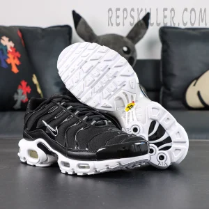 Nike Air Max Plus Black White front view with outsole display, black upper and white Air cushioning