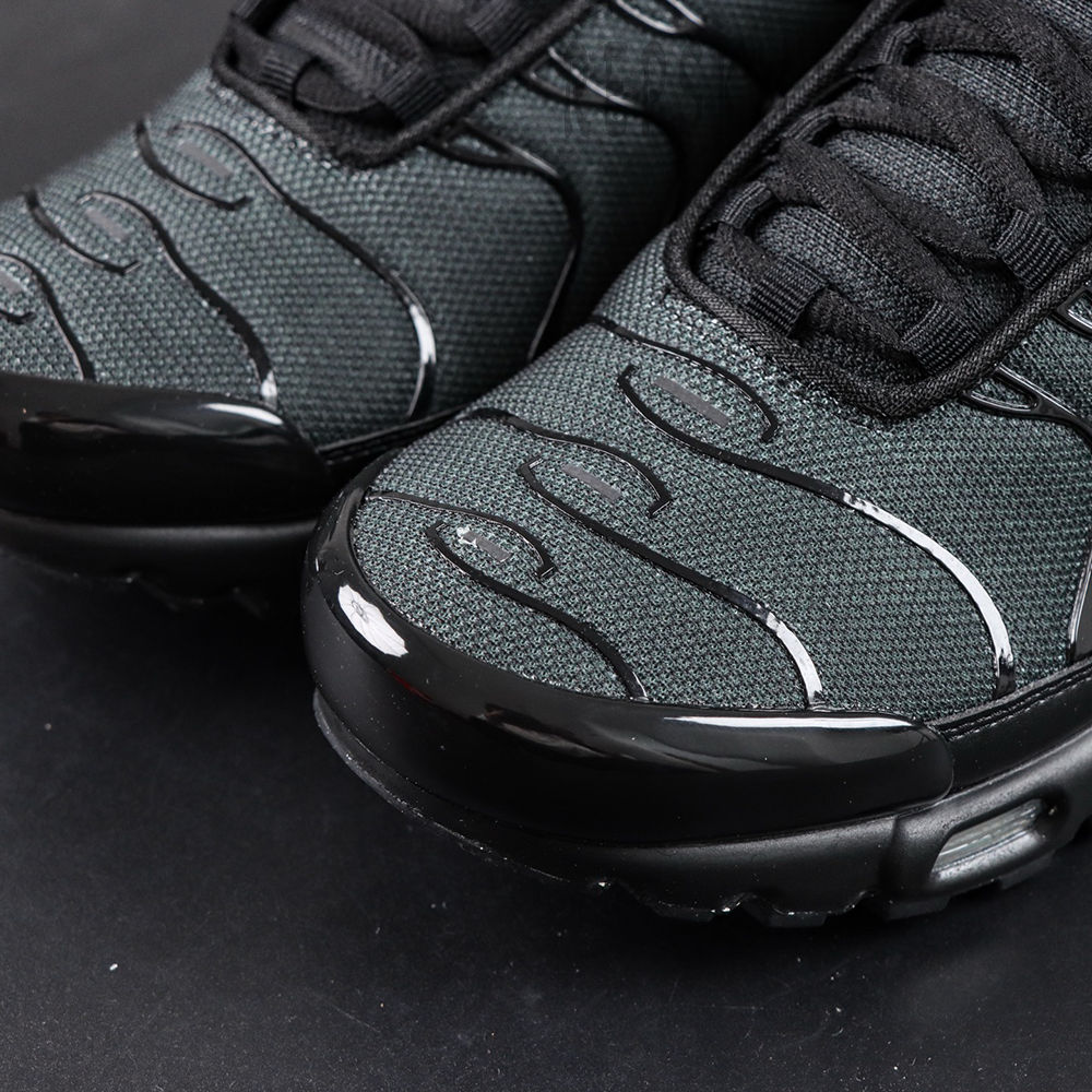 Toe box close-up of Nike Air Max Plus Multi Swoosh Black Bright Crimson with black mesh and TPU overlays