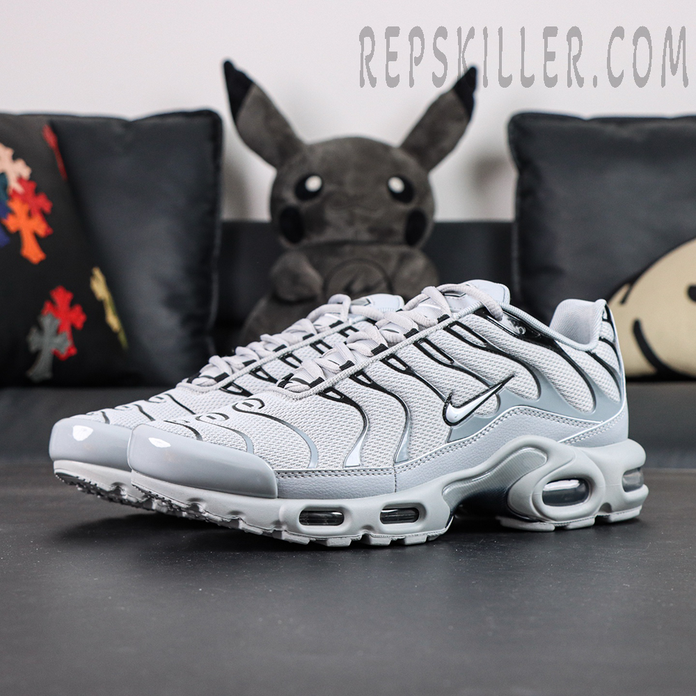 Nike Air Max Plus TN Wolf Grey sneakers shown from a front three-quarter angle with breathable mesh upper and visible Air cushioning