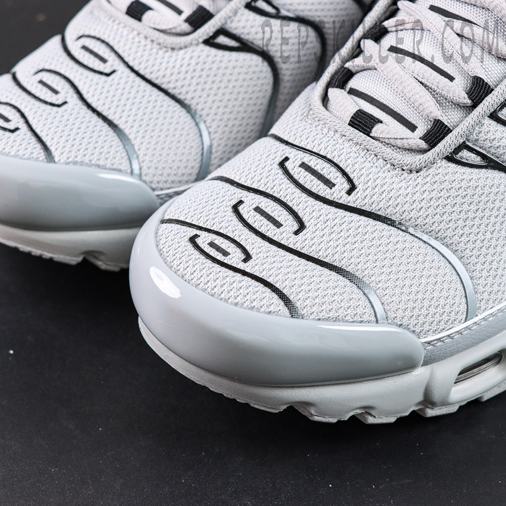 Close-up of the toe box on Nike Air Max Plus TN Wolf Grey featuring mesh material and wave-shaped TPU lines