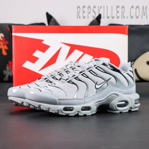 Nike Air Max Plus TN Wolf Grey displayed with original Nike shoebox in a lifestyle setting