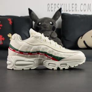 Side profile view of Undefeated x Nike Air Max 95 “Sail” with red and green Undefeated stripe