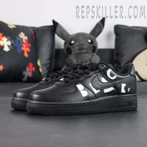 BLACK Comme des Garçons x Nike Air Force 1 Low black collaboration sneakers, front side angle with white “BLACK” lettering detail