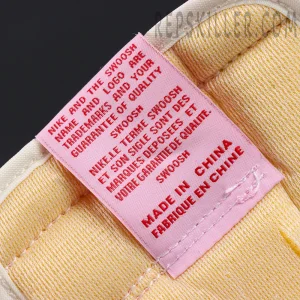 Travis Scott x Jordan 1 Low OG “Tropical Pink”, inner tongue label close-up with pink fabric and printed text