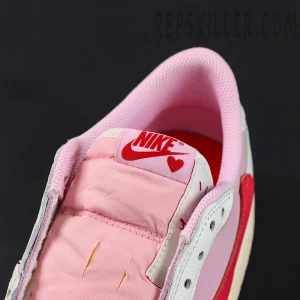 Travis Scott x Jordan 1 Low OG “Tropical Pink”, tongue front close-up with Nike Air tag and heart graphic