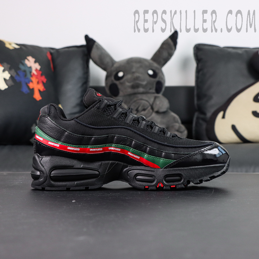 Undefeated x Nike Air Max 95 Black sneakers, side profile with UNDEFEATED red and green stripe