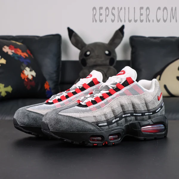Undefeated x Nike Air Max 95 “Bright Crimson” sneakers, front-side angle showing grey suede upper with red accents