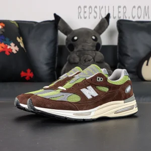 Daniëlle Cathari x Kith x New Balance 991v2 “Reverse” sneakers, lateral full view with brown and neon green color blocking