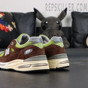 Daniëlle Cathari x Kith x New Balance 991v2 “Reverse” sneakers, rear-side angle highlighting heel and midsole