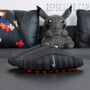 Nike Mind 001 “Black” slip-on clogs, side view with minimalist black upper and orange pod outsole