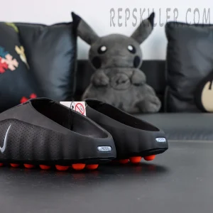 Nike Mind 001 “Black” clogs rear-side angle highlighting black upper and orange outsole contrast