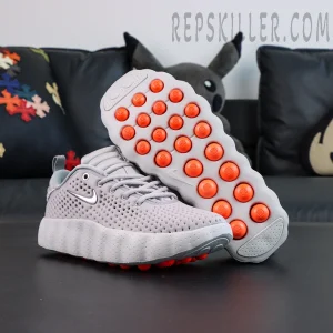 Nike Mind 002 “Light Smoke Grey” outsole with orange pods and traction system