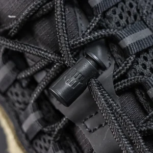 Undefeated x Nike Air Max 95 “Medium Olive” sneakers, lace system close-up with black toggle and rope laces