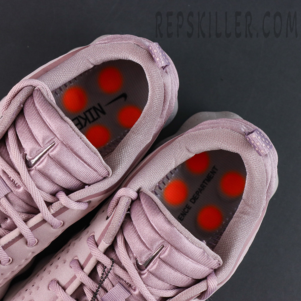 Nike Mind 002 interior view revealing orange cushioning pods on insole