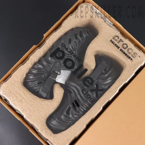 The Salehe Bembury x Crocs Pollex Clog “Sasquatch” delivers a bold, monochromatic take on the iconic silhouette, combining sculptural design with all-day comfort performance. Constructed with a fully blacked-out Croslite™ foam upper, this model showcases flowing concave ridges inspired by Salehe Bembury’s signature fingerprint motif, creating a futuristic and organic visual identity. The textured design not only enhances aesthetics but also improves structure and flexibility. Strategically placed ventilation ports promote airflow, ensuring breathable wear throughout the day. Built for functionality, the clog features an adjustable nylon heel strap for a secure and customizable fit, while dual Crocs and Salehe Bembury branding appears on the contoured footbed. Underfoot, durable rubber pods are placed in high-wear areas of the outsole, delivering enhanced traction and stability across various surfaces. Key Features: • Croslite™ foam construction for lightweight comfort and cushioning • All-black “Sasquatch” colorway for a sleek, versatile look • Signature fingerprint-inspired ridges for bold sculptural design • Ventilation ports for enhanced breathability • Adjustable nylon heel strap for a secure fit • Dual Crocs x Salehe Bembury branding for authenticity • Rubber outsole pods for improved traction and durability The “Sasquatch” Pollex Clog is perfect for those who want a minimal yet statement-making comfort shoe, blending avant-garde aesthetics with everyday practicality.