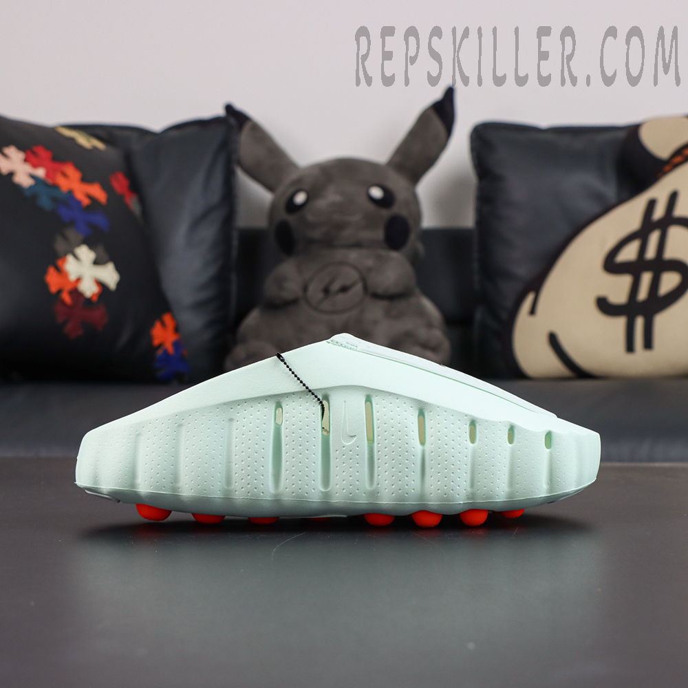 Nike Mind 001 “Barely Green” lateral side view featuring a streamlined molded silhouette and orange independent cushioning nodes
