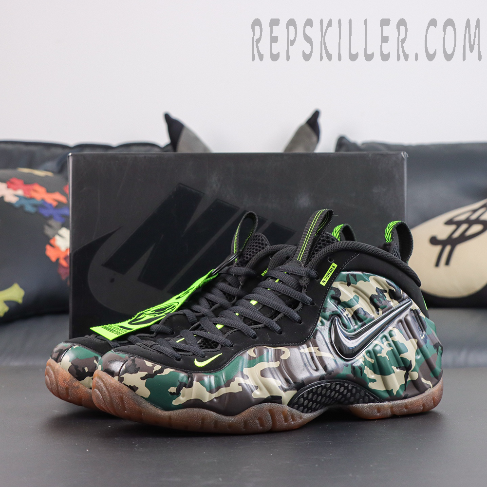 Nike Air Foamposite Pro ‘Green Camo’ angled pair view featuring camouflage Foamposite shell, black upper, neon green accents and gum outsole