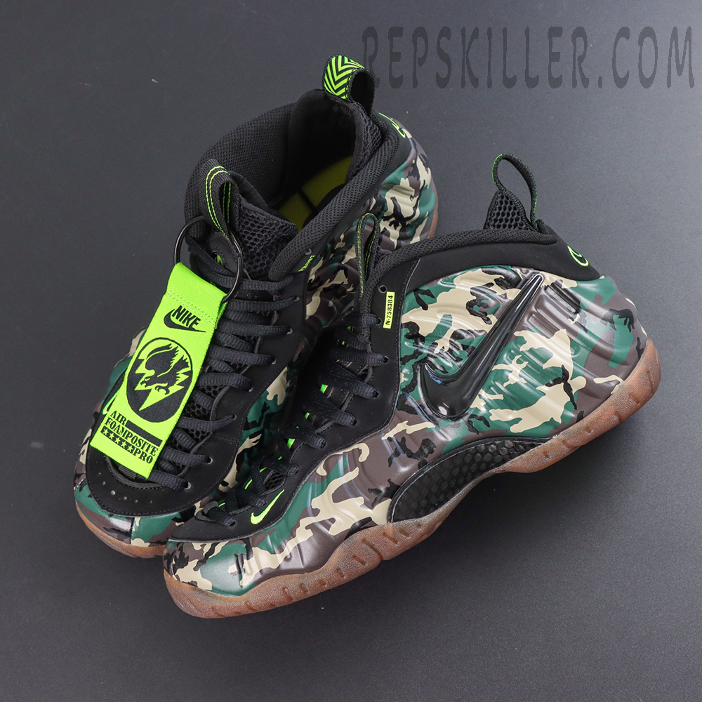 Nike Air Foamposite Pro ‘Green Camo’ top view featuring camouflage shell, black lacing system and neon green hang tag details