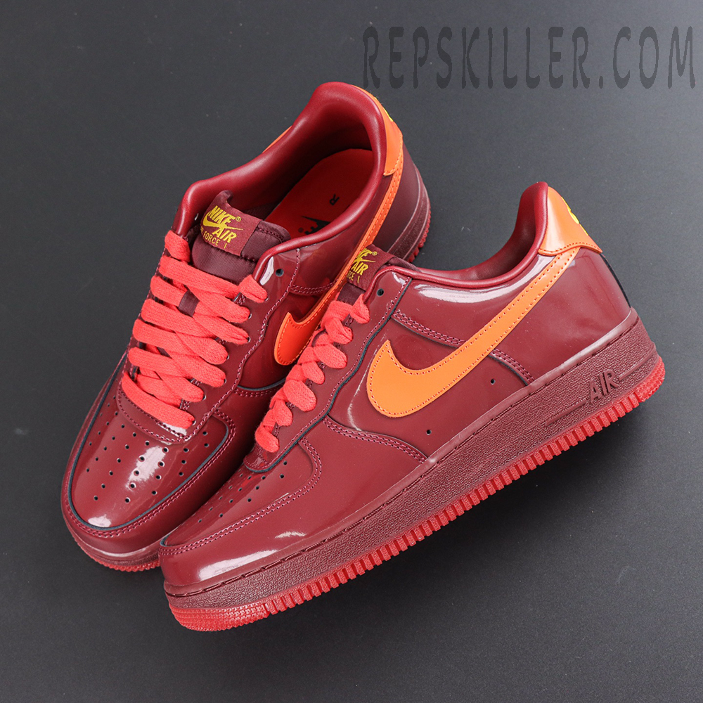 Nike Air Force 1 Low ‘Patent Leather Dark Team Red’ top view featuring burgundy patent leather, red laces and orange branding accents