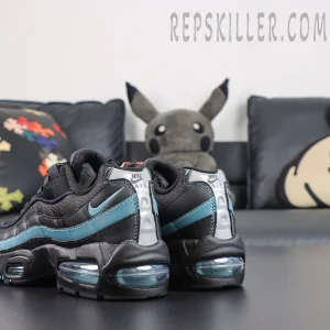 Nike Air Max 95 ‘Smokey Blue’ rear angle view featuring a black upper, smoky blue wave panels, blue Swoosh, silver Nike Air heel branding, and visible Air cushioning