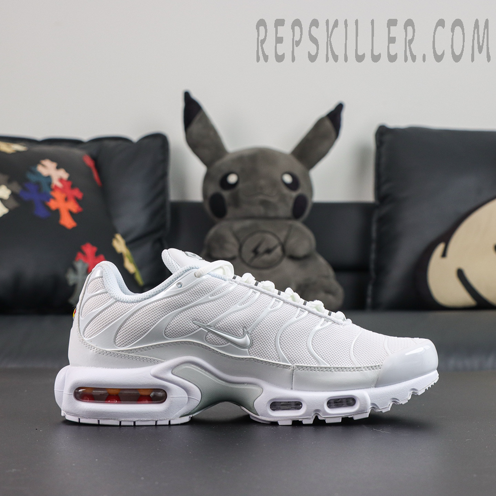 Nike Air Max Plus ‘Triple White’ side view featuring white mesh, a silver Swoosh, wave-shaped TPU overlays, and visible Air cushioning