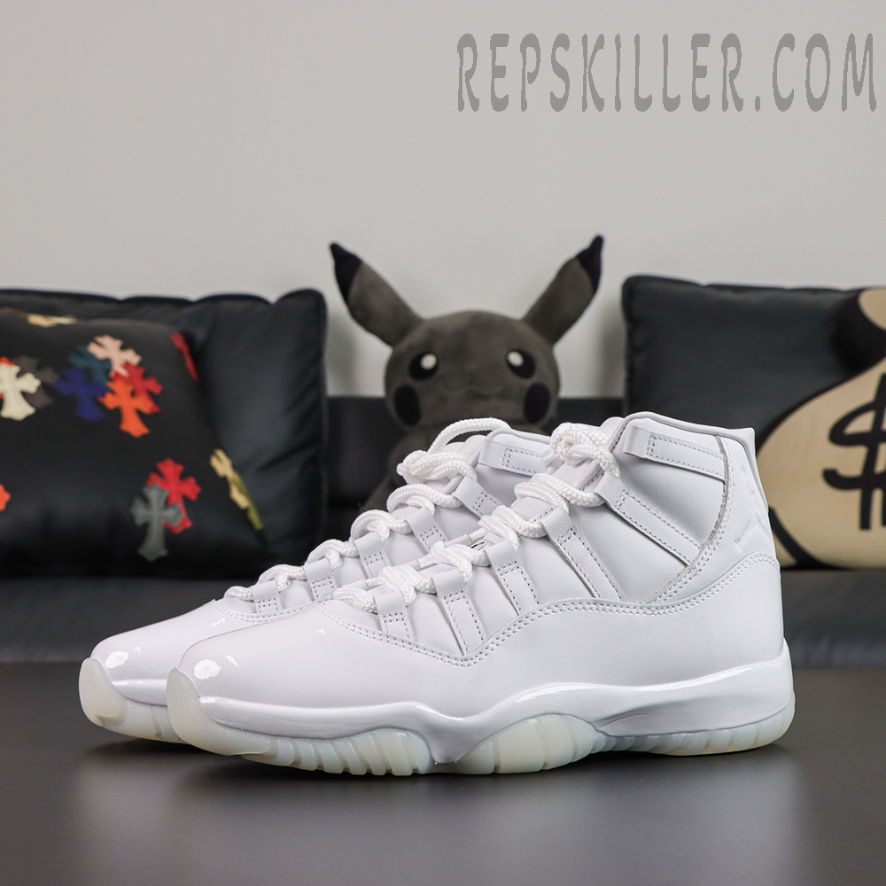 Comme des Garçons x Air Jordan 11 Retro ‘White’ front angle view featuring an all-white leather upper, glossy patent leather mudguard, white laces, and translucent outsole