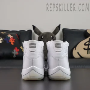 Comme des Garçons x Air Jordan 11 Retro ‘White’ rear view featuring white leather uppers, striped heel branding, collaboration details, and translucent outsoles