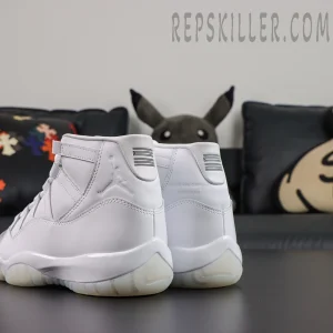 Comme des Garçons x Air Jordan 11 Retro ‘White’ rear angle view featuring embossed Jumpman branding, collaboration text, white patent leather, and translucent icy outsole