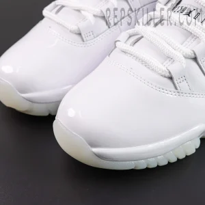 Comme des Garçons x Air Jordan 11 Retro ‘White’ toe box close-up featuring glossy white patent leather, white leather upper, thick laces, and translucent outsole edge