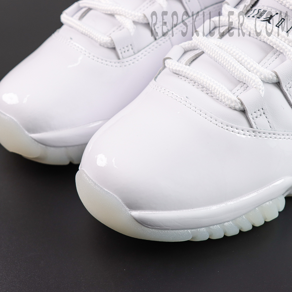 Comme des Garçons x Air Jordan 11 Retro ‘White’ toe box close-up featuring glossy white patent leather, white leather upper, thick laces, and translucent outsole edge
