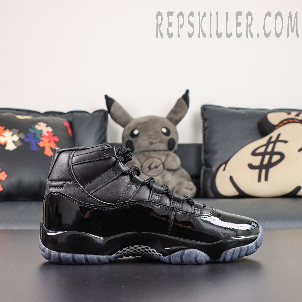 Comme des Garçons x Air Jordan 11 Retro ‘Black’ side profile featuring a black leather upper, glossy patent leather mudguard, black laces, and translucent grey outsole
